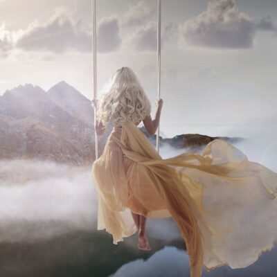 He is Love_poem by Dawn Francis_Rebel-Faith_Woman on swing in clouds looking towards mountains